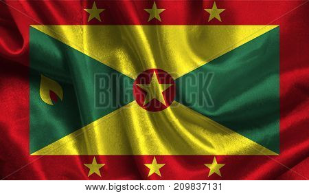 Realistic flag of Grenada on the wavy surface of fabric. This flag can be used in design.
