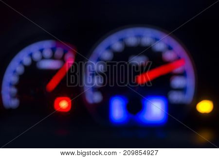 Defocused modern car dashboard. Bokeh background. Concept of drunkenness driving. Over speed