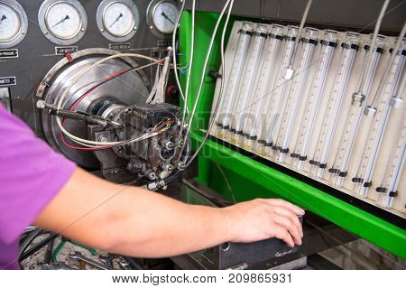 close-up high pressure diesel fuel pump test bench on work