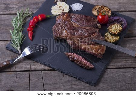 Grilled Beef Striploin Steak From Black Angus And Vegetables On Stone Plate. Salt And Papper. Top Vi