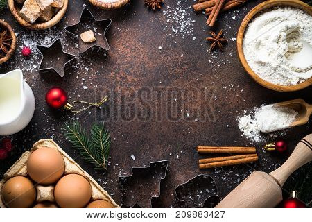 Christmas Baking background. Ingredients for cooking christmas baking on dark stone background. Top view with copy space.