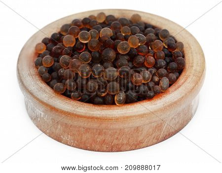 Silica gel in a wooden bowl over white background