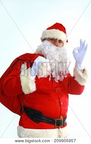 Santa Claus running with the bag of the presents.