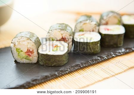 Fresh Homemade Sushi Roll. Fried Sushi On Black Slate Surface. Japanese Food