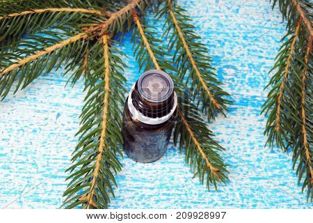 Essential oil blend. Dark glass bottles, cinnamon, pine twigs, dried citrus slice, anise, woolen wrap. Natural home deodorants. Warm toned.
