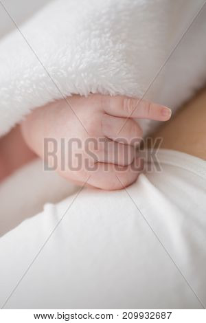 Sweet newborn baby hand. Soft image of beautiful family.