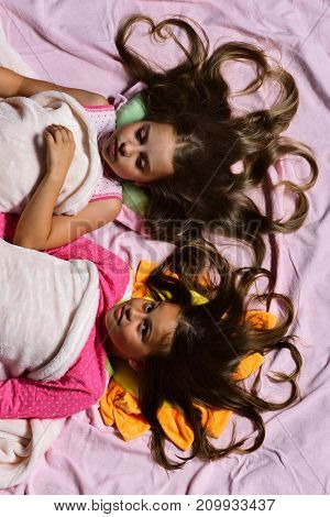 Girls Lie On White And Pink Bed Sheets