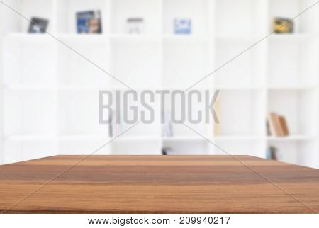 Empty wooden table and blur background of abstract in front of modern library or knowledge source can be used Mock up for display of product or for montage.