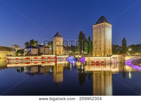Evening panorama of Strasbourg, the medieval bridge Ponts Couverts, France