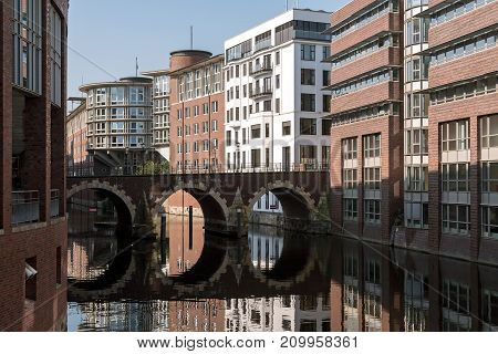 bridge with round reflection over a fleet a typical waterway in hamburg germany the old Ellerntorsbrücke leads from the city over the Herrengrabenfleet to the district altona