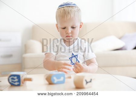 Little Jewish boy with Star of David at home