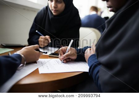 Diverse Muslim girls studying in a classroom