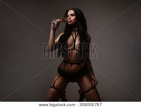 Slim Woman Dressed In Black Lingerie And Tied With Ropes. Lingerie Sexy Girl Model In Darkness. Fema