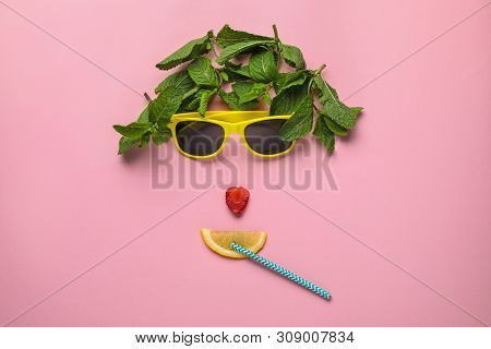 Funny Face Made Of Sunglasses, Mint, Strawberry, Cocktail Straw And Citrus Slice On Color Background