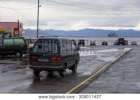 Petropavlovsk-kamchatsky, Russia- 05 October 2014: Cars On The Ca Park Near Avacha Bay. Ships Standi