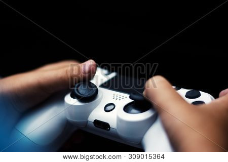 Joystick In Game Isolated In Black. Close-up Of Hands Holding Gamepad In Black Background. Games Con
