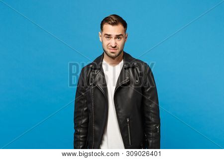 Young Sad Frustrated Worried Unshaven Man In Black Jacket White T-shirt Looking Camera Isolated On B