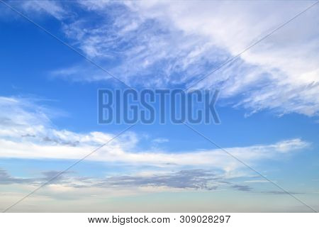 White Cirrus And Stratus Clouds High In The Blue Summer Sky. Different Cloud Types And Atmospheric P
