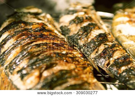 Cooking Fish On The Grill. Fried Fish. Fried Fish On The Fire. Close-up. Moment Of Cooking