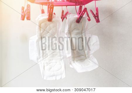 Dry Sanitary Napkin Or Feminine Sanitary Pad In The Sun Cleaning And Dried Hang On Clothespin Concep