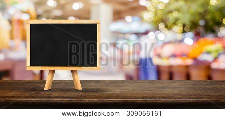 Blank Blackborad On Wooden Table Top With Blur People Shopping At Supermarket Bokeh Background,mock 