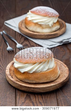 Traditional Swedish Dessert Semla, Also Called Shrove Bun, With Almond Paste And Whipped Cream Filli