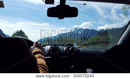 Person Rides By Car Through The Open Area. View From The Cabin
