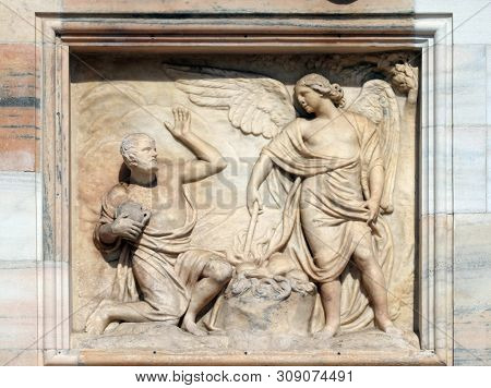 MILAN, ITALY - JUNE 22, 2018: Gideon being called by God to deliver Israel from the Midianites, marble relief on the facade of the Milan Cathedral , Duomo di Santa Maria Nascente, Milan, Italy