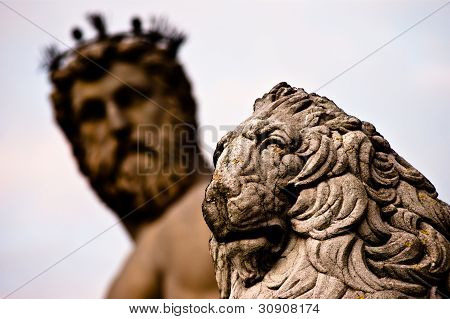 Lion Statue With Neptune In Background