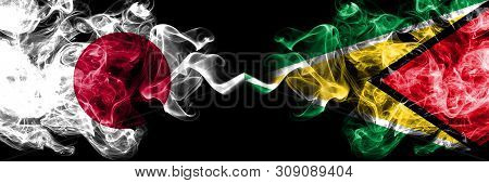 Japan Vs Guyana, Guyanese Smoky Mystic Flags Placed Side By Side. Thick Colored Silky Smokes Combina