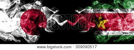Japan Vs Suriname, Surinamese Smoky Mystic Flags Placed Side By Side. Thick Colored Silky Smokes Com