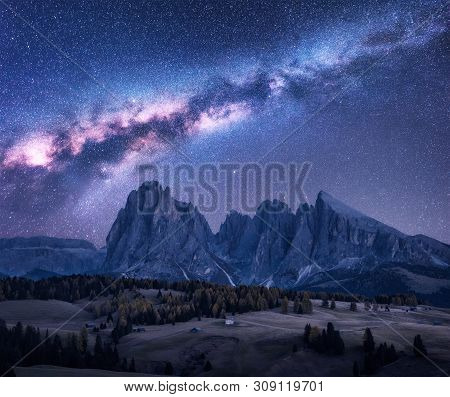 Milky Way Over Beautiful Mauntains At Night. Autumn Landscape With Mountains, Purple Sky With Stars 