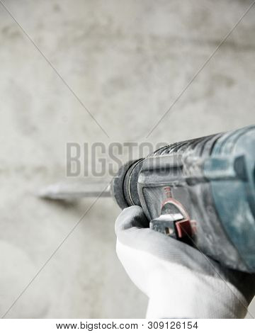 Abstraction Photo Of Noisy Repair. Electric Tool In The Hands Of A Construction Worker, Gadder Again