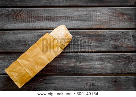 Fresh Baguette And Paper Bag For Bakery On Wooden Background Top View Mock-up