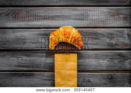 Fresh Pastry With Croissant In Paper Bag On Wooden Background Top View