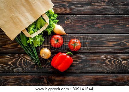 Healthy Food With Fresh Vegetables In Paper Bag On Wooden Background Top View Space For Text