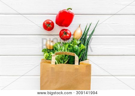 Buying Fresh Vegetables In Paper Bag On White Wooden Background Top View