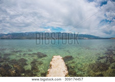 Old Stone Pier On The Adriatic Coast. Sea Coast Of Croatia. Calm Water. Beautiful Places Of European