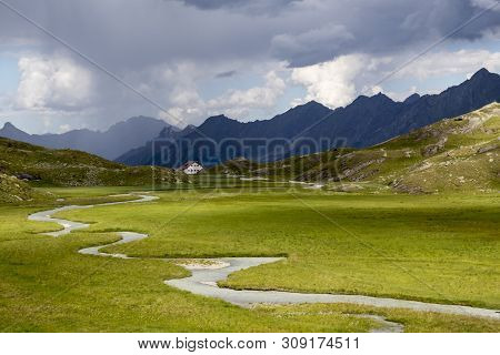 Swamp In The Alps With Hut On A Cloudy Day