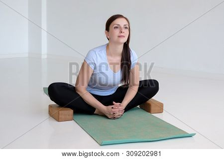 Woman Practicing Yoga, Doing Butterfly Exercise, Baddha Konasana Pose