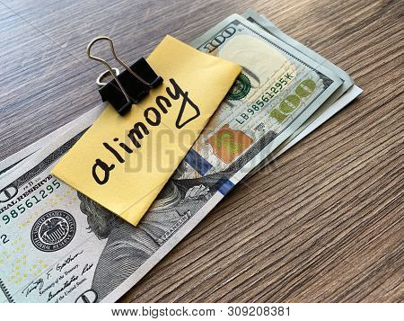 Payments Alimony. Pile Dollars With Sign Alimony And Money. Divorce And Separation Concept.