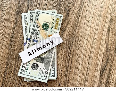 Payments Alimony. Pile Dollars With Sign Alimony And Money. Divorce And Separation Concept.
