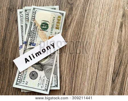 Payments Alimony. Pile Dollars With Sign Alimony And Money. Divorce And Separation Concept.