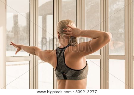 Beautiful Blonde Female Trainer Showing Her Arm And Back Muscels. Healthy, Active Lifestyle, Losing 