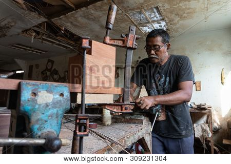 Gianyar,bali/indonesia-may 30 2019: A Guitar Craftsman Is Making Classical Guitars Made Of Wood In A