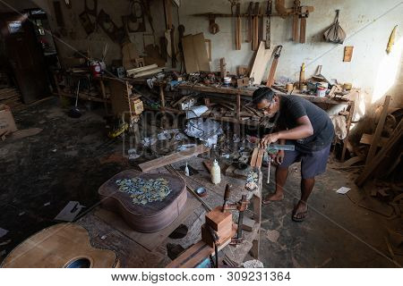 Gianyar,bali/indonesia-may 30 2019: A Guitar Craftsman Is Measuring And Make Sure It Is A Precision