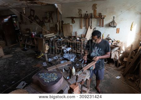 Gianyar,bali/indonesia-may 30 2019: A Guitar Craftsman Is Measuring And Make Sure It Is A Precision
