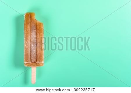 Red Bean Popsicle With A Bite On Light Green Background