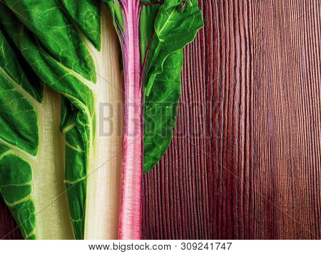Fresh Raw Leaves Of Chard, Leaf Beets, Mangold, Swiss Chard On A Wooden Table, Copy Space