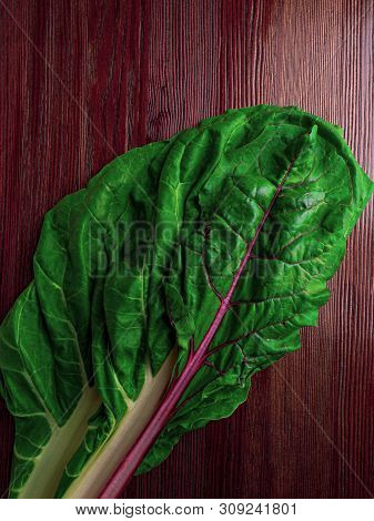 Fresh Raw Leaves Of Chard, Leaf Beets, Mangold, Swiss Chard On A Wooden Table, Copy Space